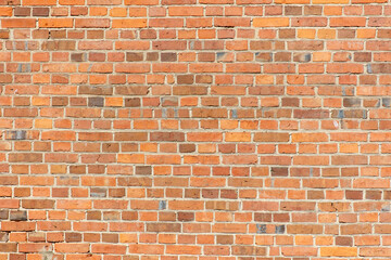 A brick wall with a red color