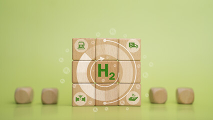 Clean hydrogen energy concept, environment, eco-friendly industry and alternative energy. Wooden block with green H2 icon, greenhouse.