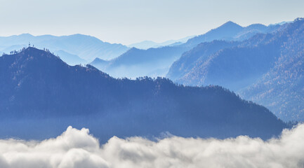 Mountains in the morning haze, peaks above the clouds