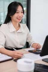 Young woman calculates stock value using calculator