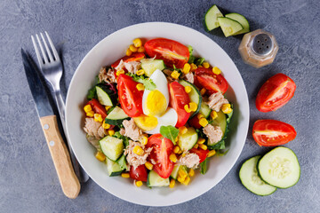 Mixed vegetable salad with tomatoes, cucumber, corn, tuna, and egg. Ideal for healthy meals and nutritious eating concepts