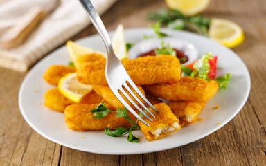 Fried fish sticks with a fork. Ideal for quick meals, snacks, and comfort food visuals