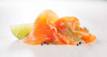 Smoked salmon slices garnished with dill and lemon. Perfect for showcasing seafood, gourmet cuisine, and healthy meal options