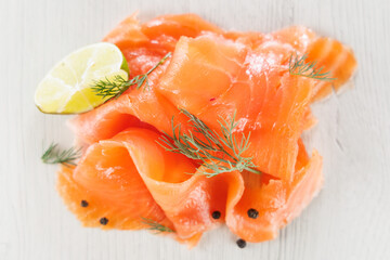 Slices of smoked salmon with dill and lemon. Ideal for gourmet food, appetizers, and healthy eating visuals