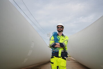 Windturbine inspector wearing Personal protective equipment working at wind turbines farm