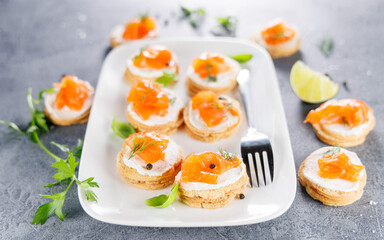 Toasts topped with cream cheese, salmon, and smoked salmon. Ideal for catering, buffet, and gourmet meal ideas