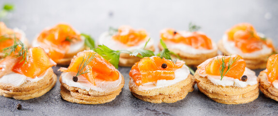 Toasts topped with cream cheese, salmon, and smoked salmon. Ideal for catering, buffet food