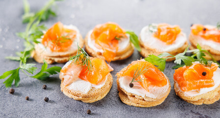 Toasts topped with cream cheese, salmon, and smoked salmon