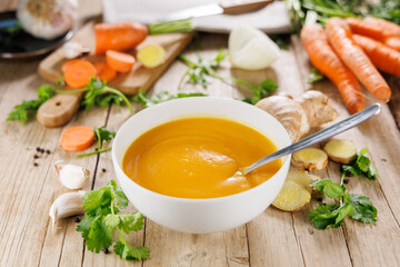 Bowl of carrot or pumpkin vegetable soup, perfect for healthy eating and comfort food visuals...