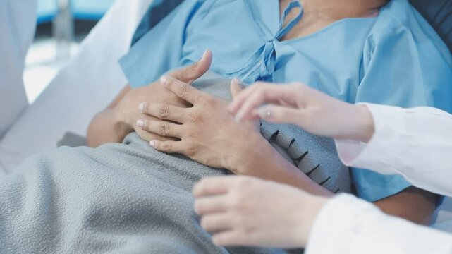 Women Asian doctors hold the patient hand and encourage and provide medical advice While checking the patient health in bed. Concept of Care and compassion, antenatal care, Threatened abortion
