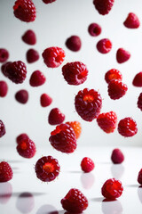 Bright raspberries fall in the background with a subtle blur effect, creating an atmosphere of freshness and juiciness of the summer harvest