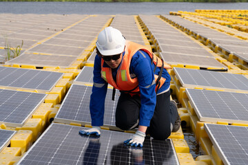 Floating solar photovoltaic panels at sustainable electrical power plant for generating clean electric energy. Concept of renewable electricity with zero emission on water surface.