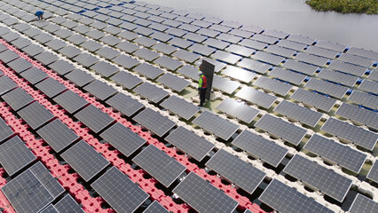 Floating solar photovoltaic panels at sustainable electrical power plant for generating clean electric energy. Concept of renewable electricity with zero emission on water surface.