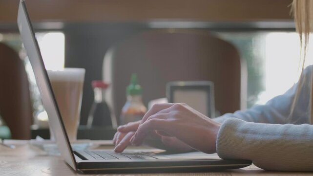 Woman typing on laptop keyboard in the office. Close up woman hands writing on laptop computer keyboard.