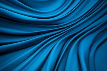 A close-up of smooth, flowing blue fabric creating elegant waves and textures, showcasing depth and richness in color.