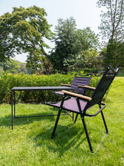 The modern black tables and chairs on the lawn.