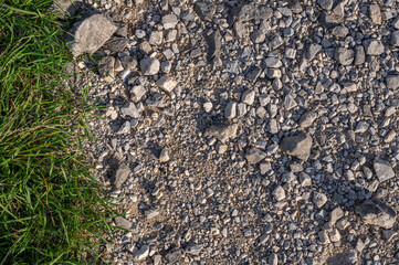 Textured Terrain: A Close-Up of Gravel and Grass
