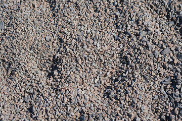 Close-up view of small gravel stones in natural sunlight at a construction site