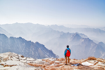 Naklejka premium Men adventuring and exploring the climb of China's Huashan Mountain.