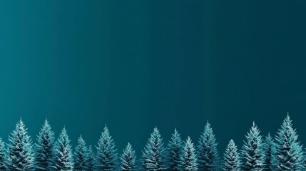 Row of snow-covered pine trees against a deep blue gradient sky