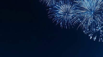 Fototapeta premium Beautiful blue fireworks lighting up the night sky in celebration