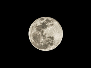Fototapeta premium Close-up photo of the moon during a full moon at night isolated on black background.