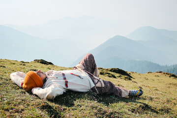 Fototapeta premium A Travler laying in grass and enjoy top of Tirthan Valley,Shangarh Himachal Pradesh, India.