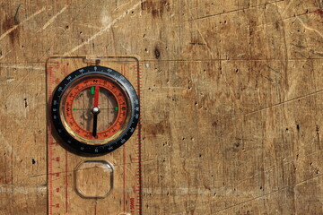 round compass on natural wooden background