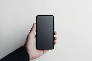 Close-up of a mobile phone against a plain white background, held by an invisible hand, showcasing the device's sleek design and modern features.