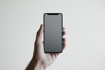 Close-up of a mobile phone against a plain white background, held by an invisible hand, showcasing the device's sleek design and modern features.