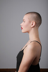 Beautiful young bald woman looking at the camera posing indoor. Mock-up.