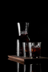 vertical view cold brew coffee with striking contrast enhances the color of the coffee looking fresh isolated on a black background. Space for text