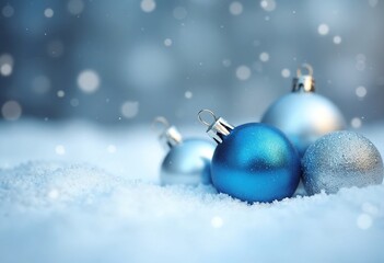 Fototapeta premium The detailed view showcases a shimmering silver and blue holiday decoration resting on soft, white snow, creating a festive winter atmosphere. The bokeh effects enhance the sparkling element