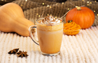 Pumpkin spice latte with whipped cream and ingredients.