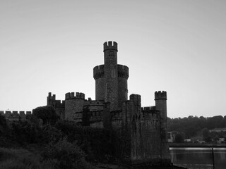 Blackrock castle observatory silhouette in the rays of sunset sun black and white monochrome background