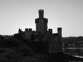 Fototapeta premium Blackrock castle observatory silhouette in the rays of sunset sun black and white monochrome background