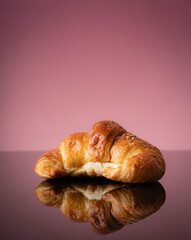 conceptual photo of fresh croissant on warm background and copy space