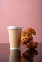  croissant with disposable cup delivery on pink background. Space for text