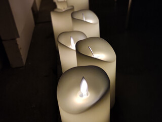 Artificial electric candles close view background, romantic atmosphere