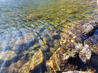 Mountain lake relaxation, pure waterscape natural background. Laying somewhere in the mountains