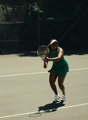 Tennis player ready on court, preparing for a powerful shot