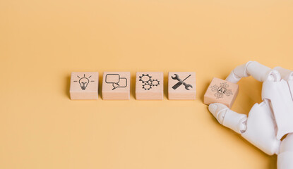 Robot hand holding AI icon, concept of working and helping humans to develop business and create...
