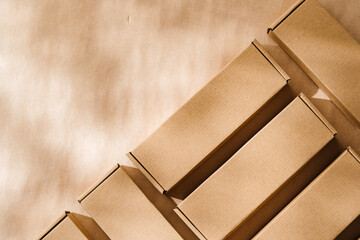 Brown cardboard boxes arranged on a neutral background in a warehouse setting during daylight hours