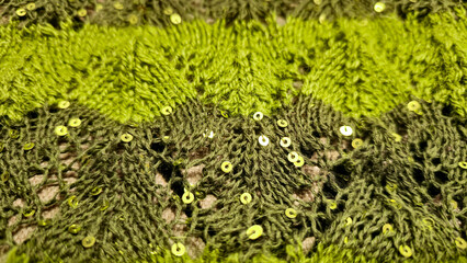 Handmade knitted items. Knitted fabric made of colored threads. cardigan pattern