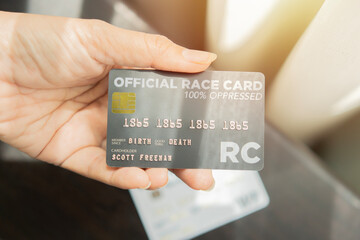 Top view close-up shot of female hand holds black bank credit card with online service.