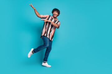 Full size photo of nice young man dancing wear shirt isolated on teal color background