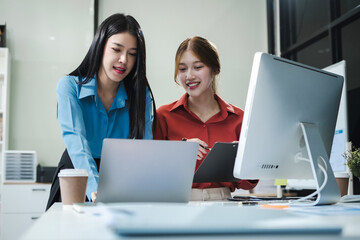 Business, technology and office concept - businessmen with laptop, tablet pc computer and papers having discussion in modern office.