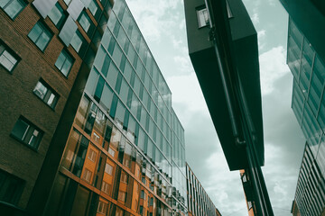 Low angle view of buildings against cloudy sky