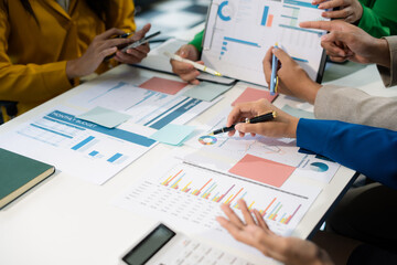 financial asian advisor showing plan of investment to clients in the consultancy office.