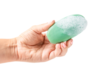 Palm of hand holding hygienic antibacterial natural soap bar of green colour wet soapy and covered with foam bubbles isolated on white background used as toiletries for washing and cleaning at bath